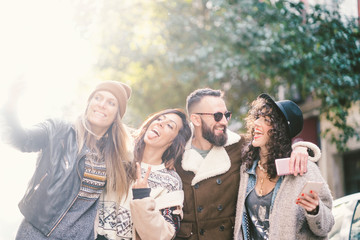 Group of friends on the street walking around having fun