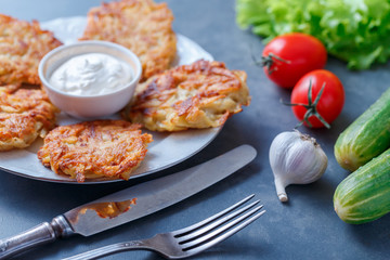 Draniki - potato fritters. potato pancakes lie on a plate. The national dish of Belarus, Ukraine, Russia.