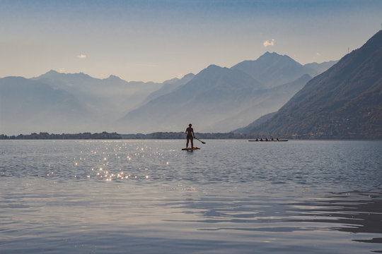 mom and kid on a stand up paddle in the lake - Powered by Adobe