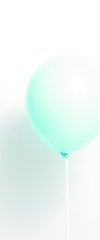 Green balloon on white background with shadow. Strong light.