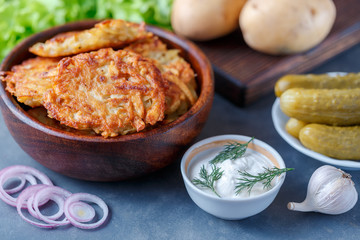 Draniki - potato fritters. potato pancakes lie on a plate. The national dish of Belarus, Ukraine, Russia.