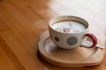 A cup of Latte coffee on wooden desk, Relaxing time or coffee's break time during work day