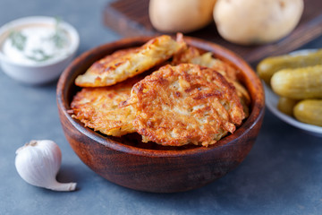 Draniki - potato fritters. potato pancakes lie on a plate. The national dish of Belarus, Ukraine, Russia.