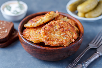 Draniki - potato fritters. potato pancakes lie on a plate. The national dish of Belarus, Ukraine, Russia.