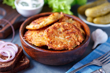 Draniki - potato fritters. potato pancakes lie on a plate. The national dish of Belarus, Ukraine, Russia.