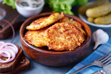 Draniki - potato fritters. potato pancakes lie on a plate. The national dish of Belarus, Ukraine, Russia.