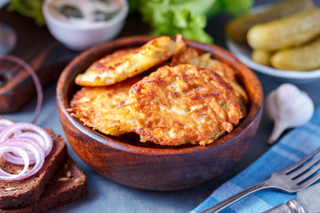 Draniki - potato fritters. potato pancakes lie on a plate. The national dish of Belarus, Ukraine, Russia.