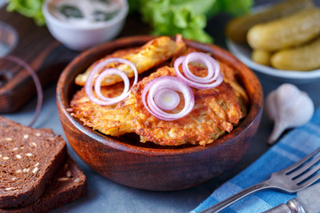 Draniki - potato fritters. potato pancakes lie on a plate. The national dish of Belarus, Ukraine, Russia.