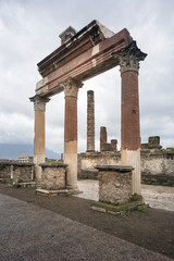 Fototapeta na wymiar grand arch from three columns in Pompei in Italy