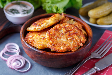 Draniki - potato fritters. potato pancakes lie on a plate. The national dish of Belarus, Ukraine, Russia.
