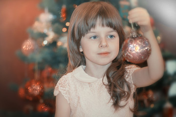 Young girl christmas portrait with red sparkling toys