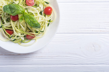 Zucchini pasta noodles with tomatoes . Healthy vegetarian food
