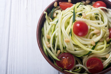Zucchini pasta noodles with tomatoes . Healthy vegetarian food