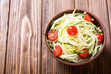 Zucchini pasta noodles with tomatoes . Healthy vegetarian food