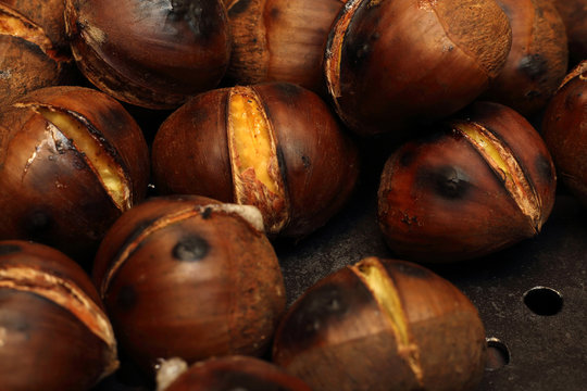 Roasted Chestnuts on a drilled Skillet, closeup view