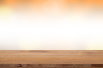 Empty desk with blurred light orange gradient bokeh abstract background
