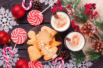 Christmas eggnog in glass mug and cinnamon.