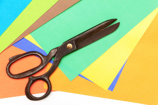 color craft paper and big black scissors. view from above