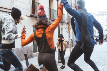 group of friends they're taking pictures on the street