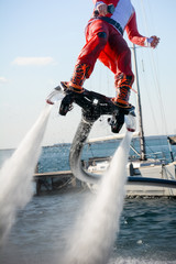 Naklejka premium Vertical View of Santa Claus Flying on Flyboard on Blur Background