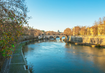 Fototapeta na wymiar Rome (Italy) - The Tiber river and the monumental Lungotevere. Here in particular the Isola Tiberina island.