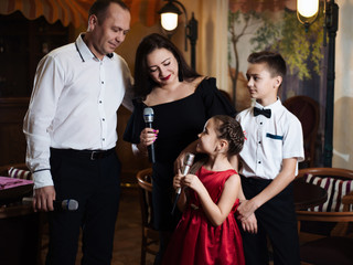 Family karaoke. Portrait of a happy family, singing in microphones