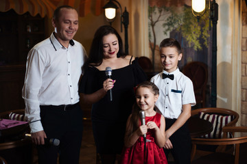 Family karaoke. Portrait of a happy family, singing in microphones