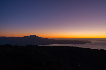 Aerial view with drone from the ski center in the volcano Osorno, Puerto Varas. With Lake Llanquihue and the Calbuco Volcano at sunset 