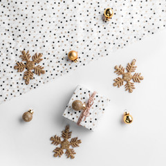 Christmas gift boxes on wrap background with gold decoration and pine cones. Xmas and Happy New Year theme. Flat lay, top view, wide composition
