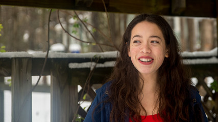 Young asian teen standing in snow