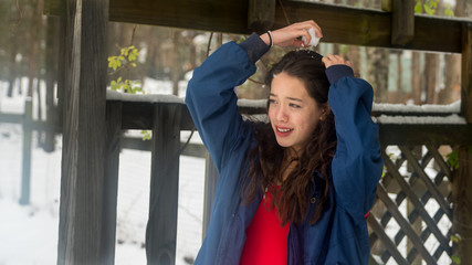 Young asian teen standing in snow