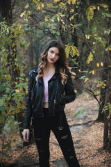 Young woman wearing leather jacket in nature