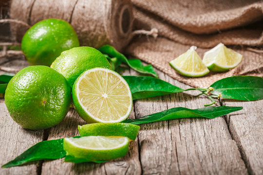 Fresh ripe limes on wooden table, rich source of Vitamin C, often used to accent of food and beverages