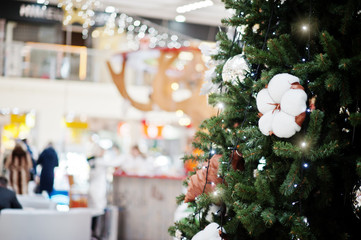 Large New Year tree with decorations in shopping mall.