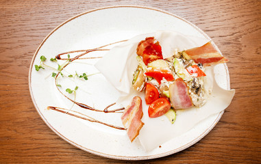 slices of roasted bacon on a white plate as appetizer