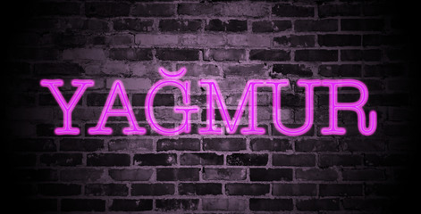 Fototapeta na wymiar first name Yagmur in pink neon on brick wall