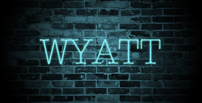 first name Wyatt in blue neon on brick wall