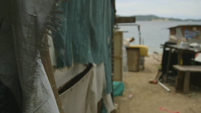 Extreme close-up still shot of floating shacks of Koki hanuabada slum. Sacks and pieces of clothes are used to cover upper stalls of the stilt supported structures.