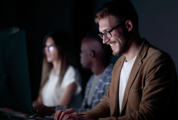 close up.smiling businessman typing on the computer keyboard