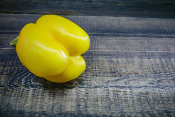 yellow pepper on wooden background