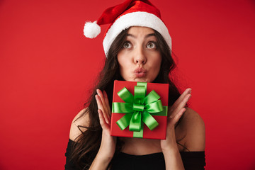 Excited young woman wearing Santa hat