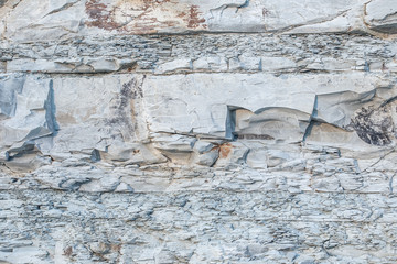 Texture Or Background Of Cut Of Breakaway Rock. Layers Of Rock Cut. Grey Layered Background