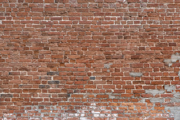 Old Red And Brown Brick Wall Rough Texture. Distressed Building Facade. Textured Urban Background.