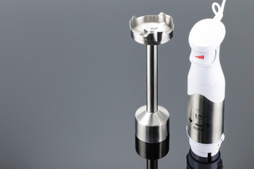 Blender with accessory on the grey mirror background with copy space