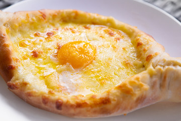 Adjarian Khachapuri In Restaurant. Open Bread Pie With Cheese And Egg Yolk. Yummy Georgian Cuisine. Adjarian Khachapuri In Restaurant. Bread Pie With Cheese And Egg. Yummy Georgian Cuisine.