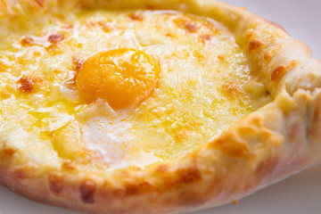 Adjarian Khachapuri In Restaurant. Open Bread Pie With Cheese And Egg Yolk. Yummy Georgian Cuisine. Adjarian Khachapuri In Restaurant. Bread Pie With Cheese And Egg. Yummy Georgian Cuisine.