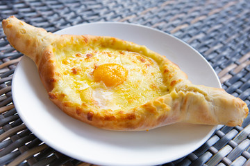 Adjarian Khachapuri In Restaurant. Open Bread Pie With Cheese And Egg Yolk. Yummy Georgian Cuisine. Adjarian Khachapuri In Restaurant. Bread Pie With Cheese And Egg. Yummy Georgian Cuisine.