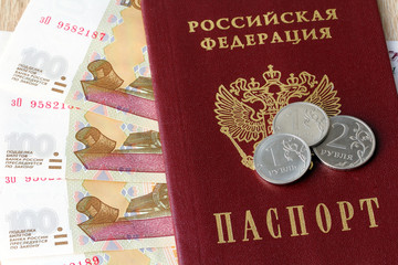 Russian passport, banknotes and coins. Concept financial crisis. Background of ruble Russia.