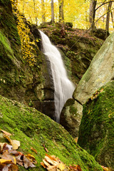 Cascade Falls among leaves and moss covered boulders in Nelson Ledges State Park on a beautiful Autumn day