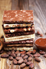 Chocolate bars on table with chocolate tower.